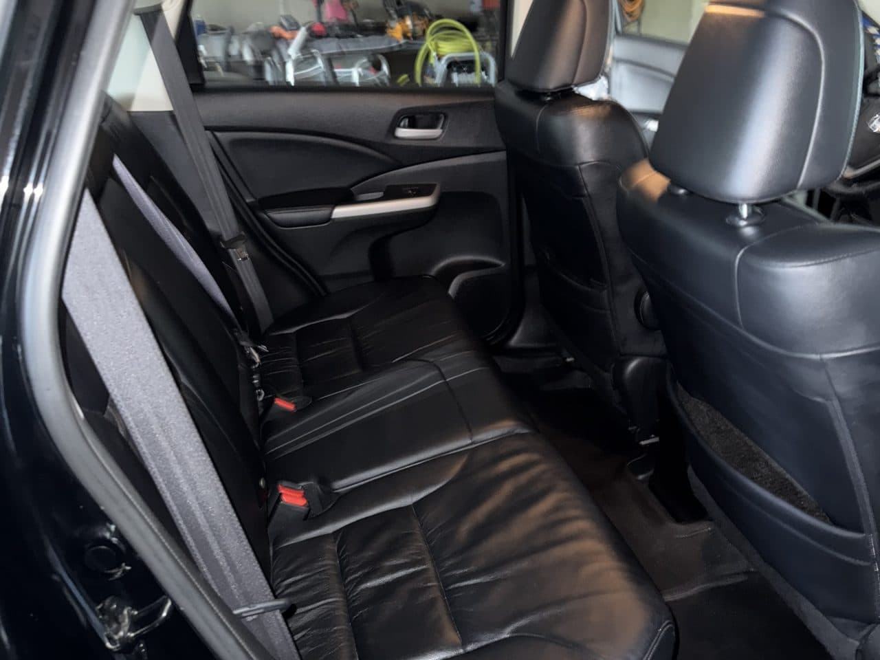 Clean, conditioned black leather rear seats in a detailed Honda CR-V